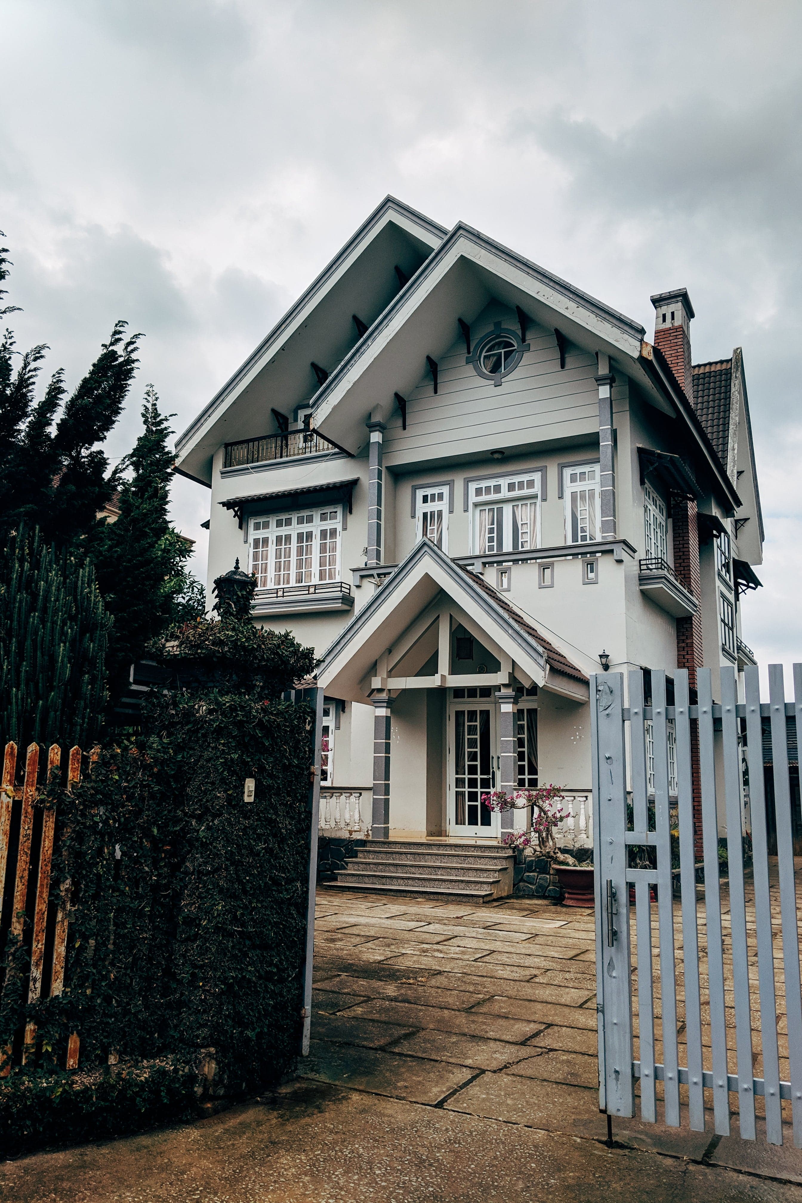 A charming house with a front gate, representing property selling